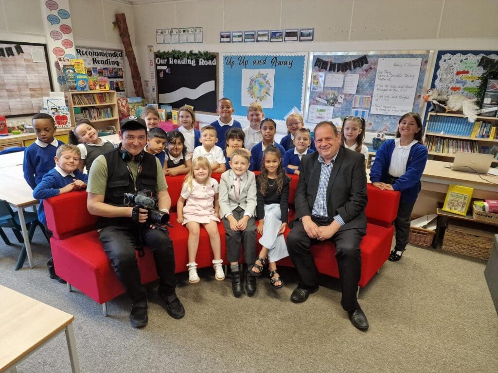 The BBC Midlands Today team on the famous red sofa with Hadley Learning Community primary pupils