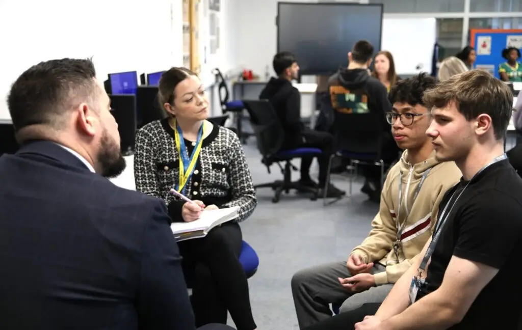 T Level students talking to Ercall Wood Academy head Nick Murphy